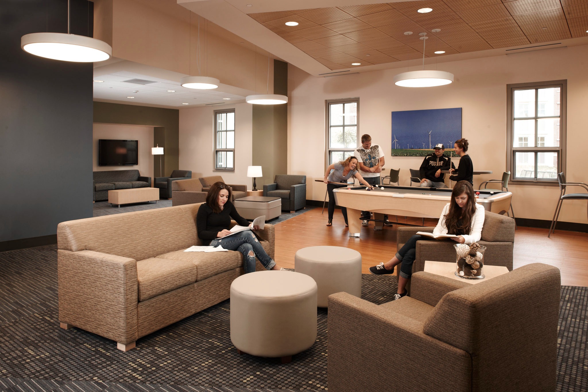 lounge with beige sofas and people