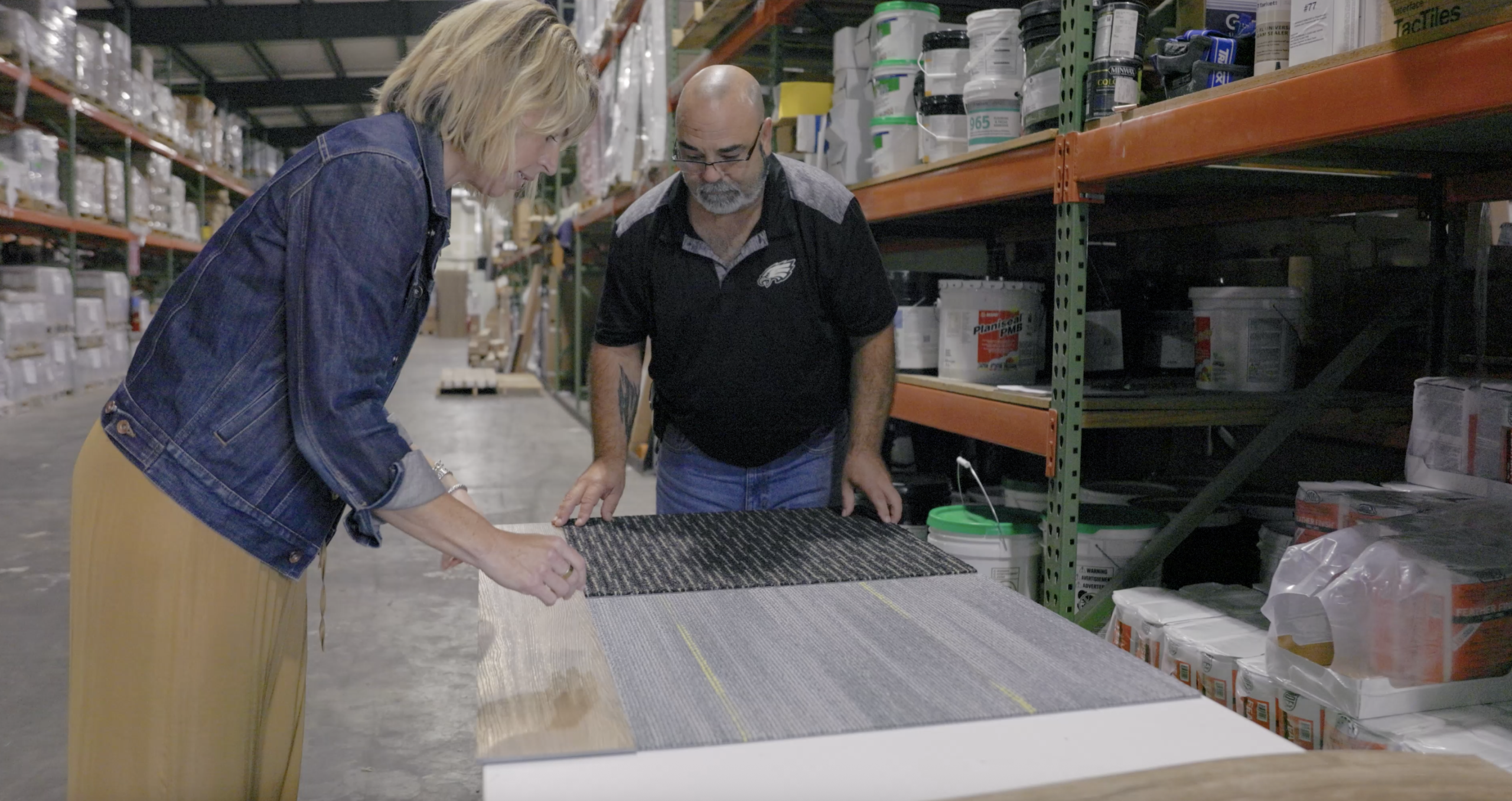 two people comparing floor options in a storage building
