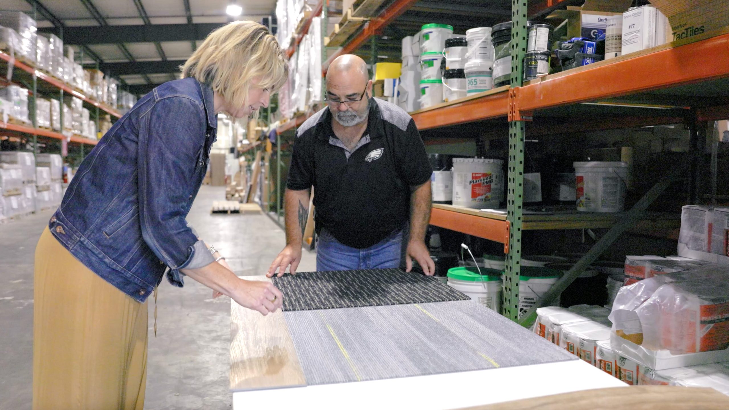 two people working on a carpet sample